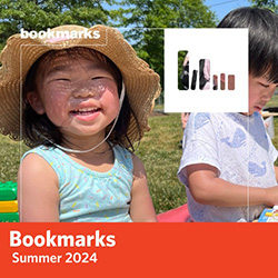 Bookmarks Summer 2024 - a young child smiles at the camera sitting next to another child